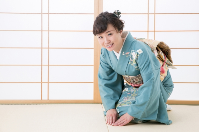woman in blue flower kimono bowing